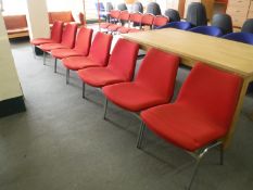 Seven reception chairs on chrome legs in a red fabric