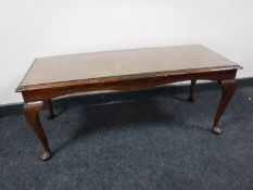 A walnut glass topped coffee table