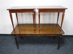 A 20th century walnut coffee table and a pair of mahogany side tables