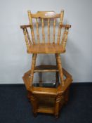 An octagonal glass top coffee table and a pine kitchen armchair