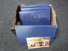 A box containing four folders of Royal Doulton collectors catalogues