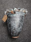 An Eastern style pottery vase with sunburst rim