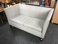 A late 20th century two seater settee in grey fabric