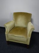 A mid 20th century armchair in gold dralon