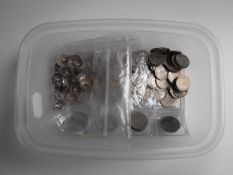 A tub of silver six pence's and three penny pieces,