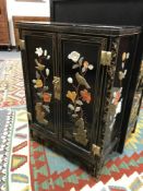 An Oriental lacquered and inlaid low cabinet,