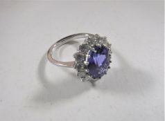 An 18ct white gold tanzanite diamond cluster ring, size N/O.
