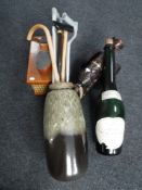 A West German stick pot containing walking sticks together with a French champagne bottle,