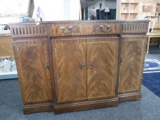 An inlaid mahogany Regency style four door break front sideboard