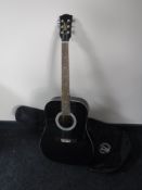 A Signature Series acoustic guitar in a Gibson Baldwin carry bag