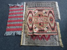 A Kilim fringed rug and three other rugs