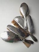 A six piece sterling silver backed brush set