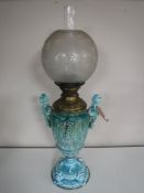 A Victorian glazed pottery oil lamp with chimney and shade