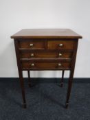 A mahogany four drawer chest on reeded legs
