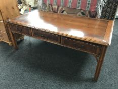An inlaid yew wood coffee table