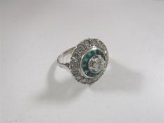 An emerald and diamond cluster ring,