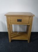 A contemporary oak two tier side table fitted a drawer