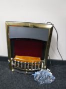 A brass framed electric fire