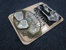 A tray containing a petit point dressing table set, two plated toast racks, plated dish,