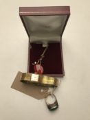 A silver polished jade ring together with a gilt metal wrist watch and a pendant on chain.