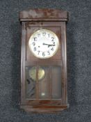 An early 20th century oak cased wall clock with silvered dial