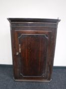 A Georgian oak hanging corner cupboard
