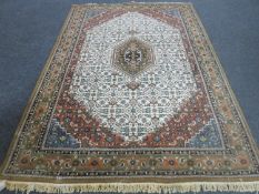 A fringed Indian carpet on brown ground