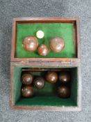 An early 20th century wooden box containing French wooden boules