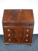 An inlaid mahogany Regency style bureau