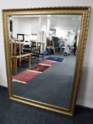 A large gilt framed bevel edge overmantel mirror