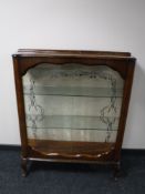 A twentieth century walnut sliding glass door display cabinet