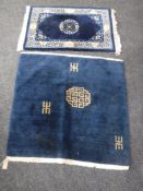 Two fringed Chinese rugs on blue ground