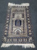 A fringed Persian prayer rug