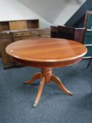 A circular inlaid mahogany pedestal dining table with leaf