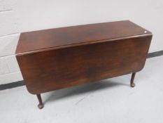 An antique mahogany gate leg table