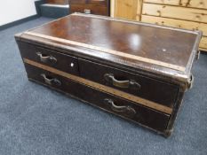 A contemporary leather and canvas coffee table in the form of a shipping trunk