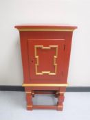 A painted cabinet on stand
