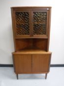 A mid 20th century teak corner cabinet