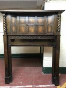 An early twentieth century oak fire surround with barley twist column supports