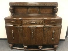 An early twentieth century carved oak buffet sideboard,