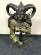 A patinated metal bust of a warrior maiden,