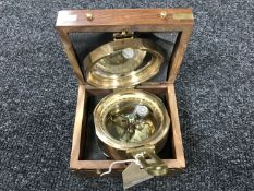 A brass nautical compass in fitted box