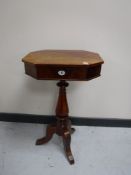 A late 19th century mahogany work table on three way pedestal