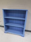 A set of painted open bookshelves