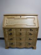 A blonde oak serpentine fronted bureau CONDITION REPORT: 100cm wide by 106cm high