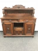 A Victorian carved oak Green Man sideboard,