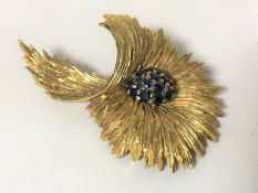 An 18ct gold sapphire floral spray brooch