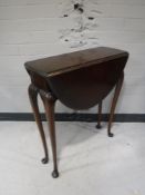 A mahogany flap sided table