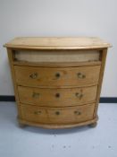 An antique pine bow fronted mule chest