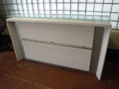 A contemporary glass topped reception desk